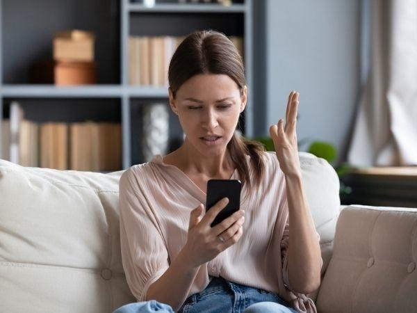 Woman staring angrily at phone 