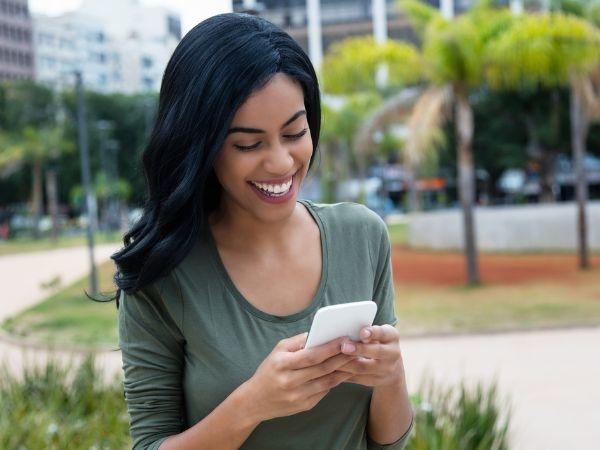 Woman laughing at phone