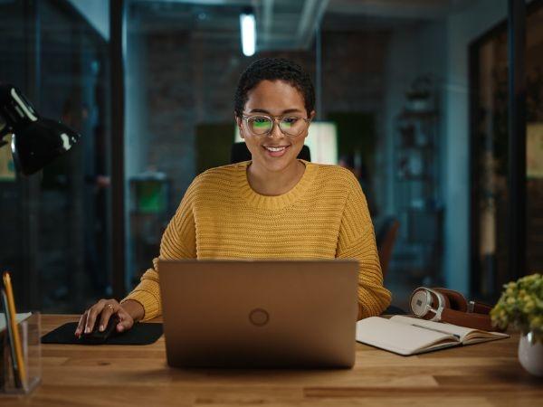 Young woman on a laptop at night 