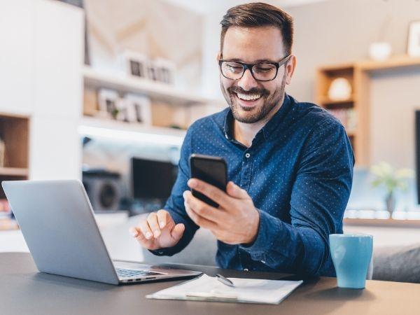 Man laughing at his phone 