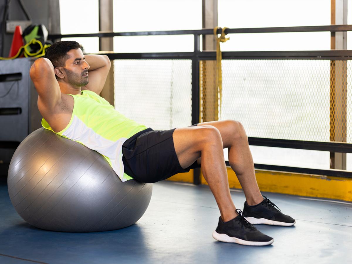 Using a stability ball as a chair to engage core muscles