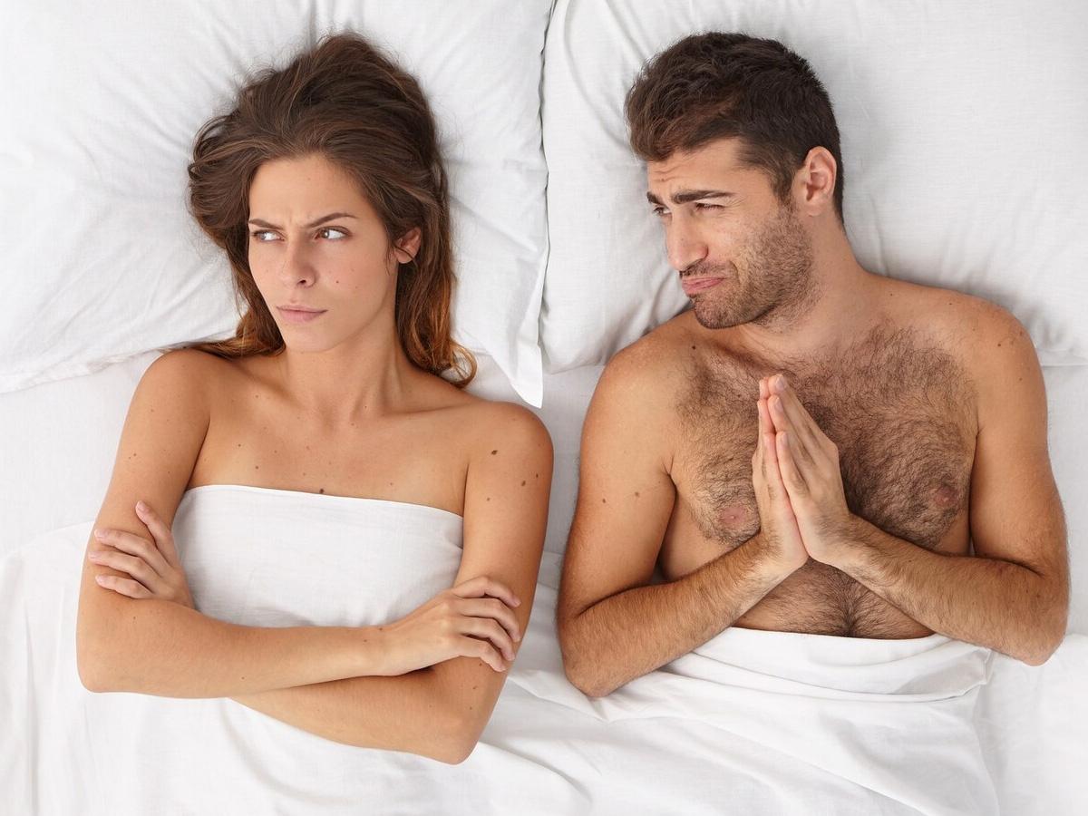 Couple in bed fighting