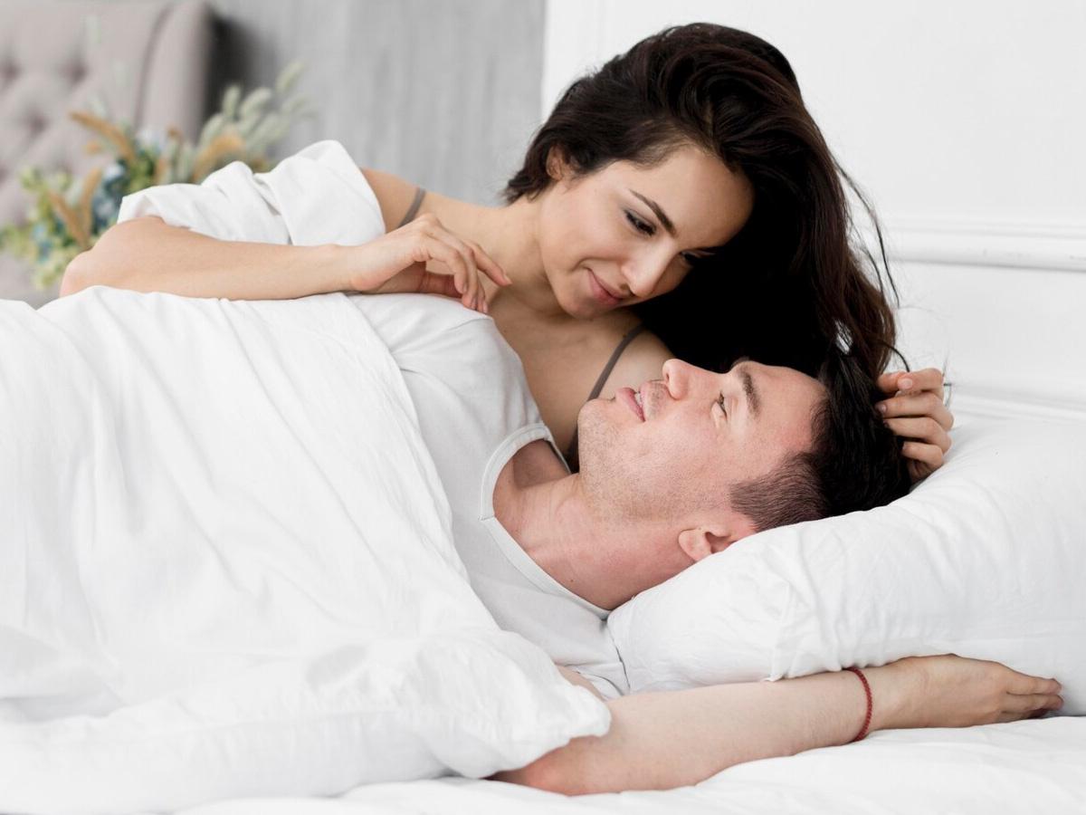 Couple in bed cuddling, 