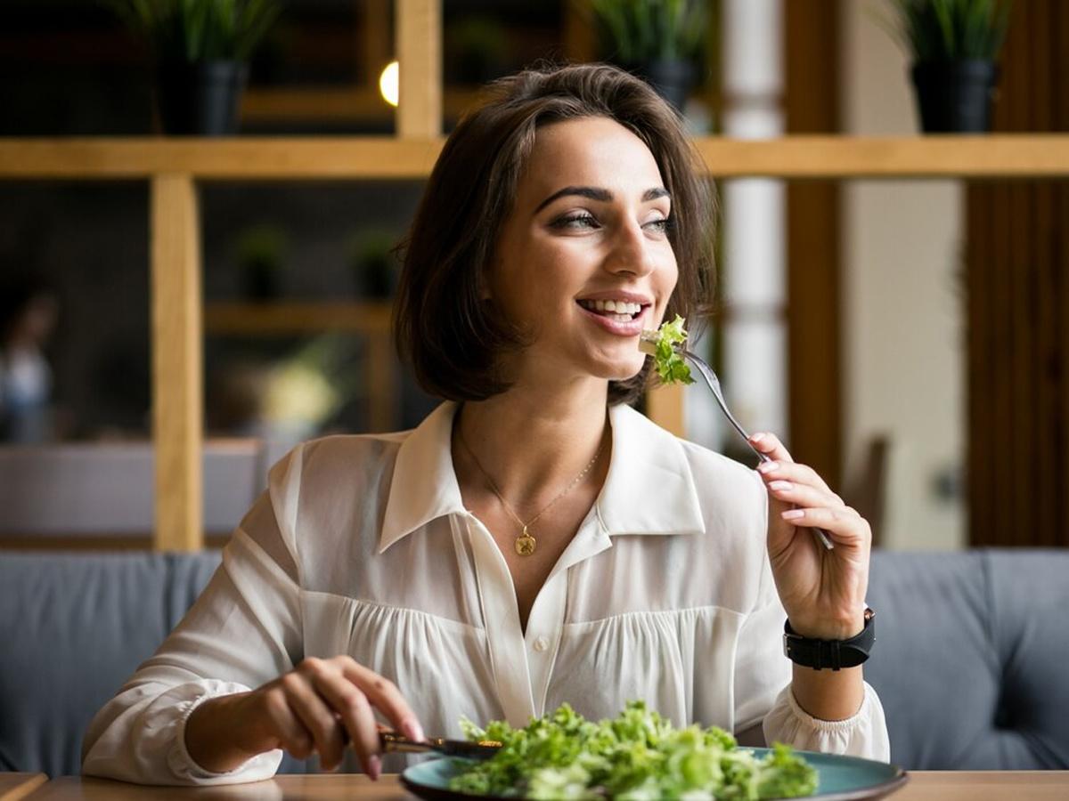 Woman eating and smiling, 